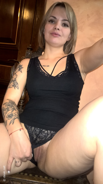 Short-haired hottie shows her small perky tits