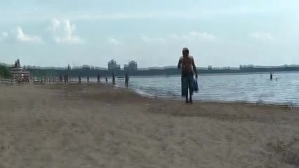 Sexy girl in a mini skirt is naked on the beach