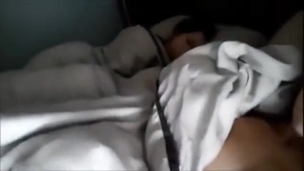 Girl masturbates while her friend is sleeping in bed