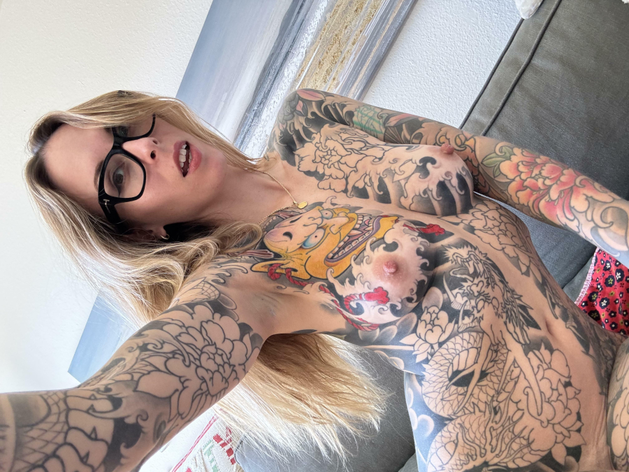Tattoos and thick glasses