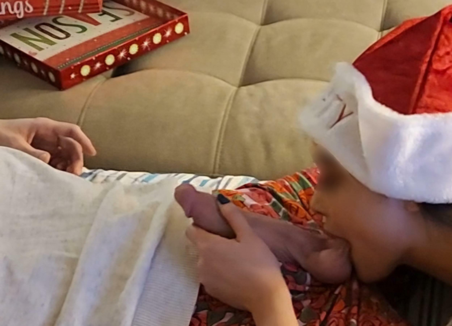 Wearing a Santa hat and opening my gift early.